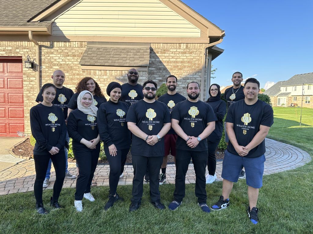 The Wealth Home Lending team standing outside a client's home